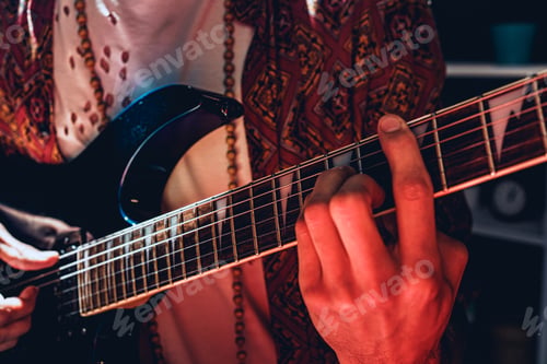 Preview: Close up photo of male hands playing guitar