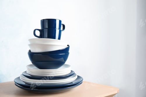 Preview: Set of dinnerware on table against light background with space for text. Interior element