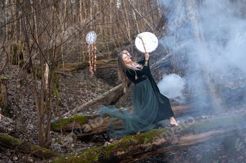 Preview: Wild Woman Playing Shamanic Drum Standing On Green Moss Tree Trunk In Forest, White Smoke Bomb