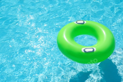 Preview: Inflatable ring floating in swimming pool on sunny day. Space for text