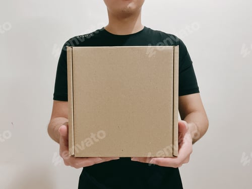 Preview: A man holding a cupboard box - mock-up friendly