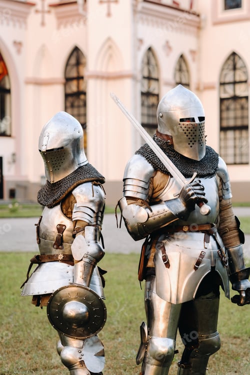 Preview: Two knights in armor on the background of the medieval Kossovsky castle.A medieval concept.Metallic