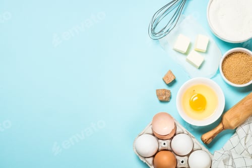 Preview: Baking ingredients at blue table top view.