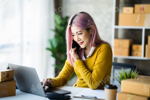 Preview: Smiling Young Woman Working at Desk with Laptop