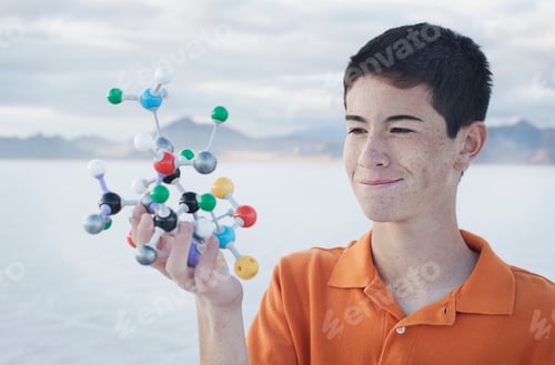Preview: A teenage boy holding a molecular model in his hand