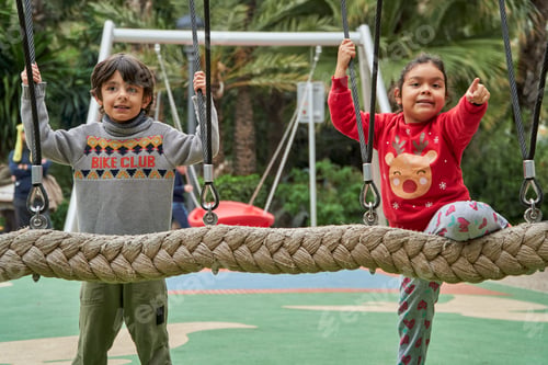 Preview: Multiethnic kids with Christmas sweaters at the park