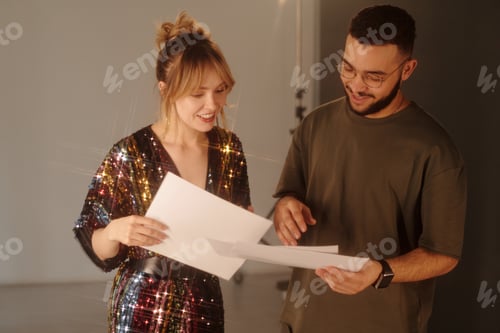 Preview: Woman and Director Reading Script Notes during Studio Shoot