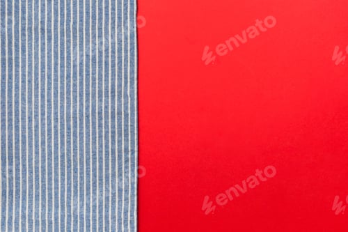 Preview: top view with blue kitchen napkin isolated on table background. Folded cloth