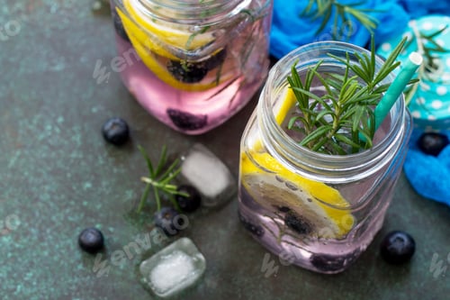 Preview: Lemonade or cocktail with blueberries and rosemary.
