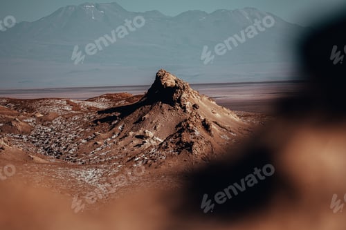 Preview: Desert landscape with rocky formation and distant mountains