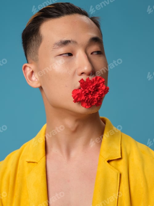 Preview: Handsome Asian man with a flower in his teeth and a yellow coat fashion style