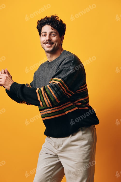 Preview: Man portrait smile orange sweater young fashion standing background student natural attire trendy