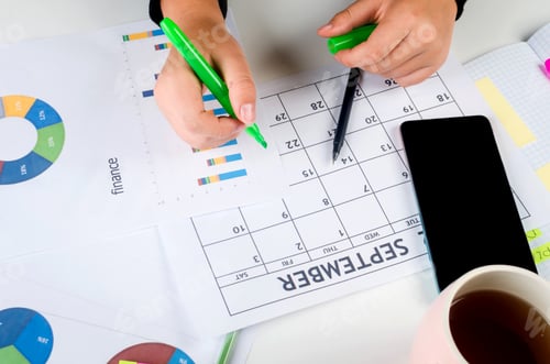 Preview: Girl Hands With Mobile Phone With Calendar Writing And List Of Work In Diary On Desk