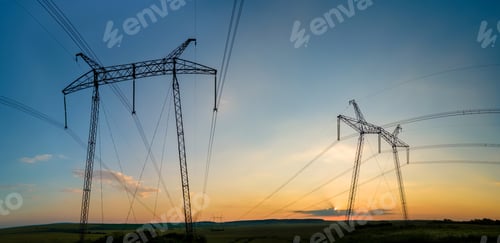 Preview: High voltage towers with electric power lines at sunset.