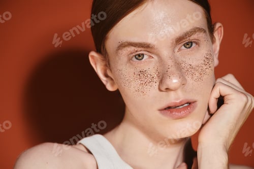 Preview: Stylish young queer man with red hair showcasing modern beauty and confidence during daylight