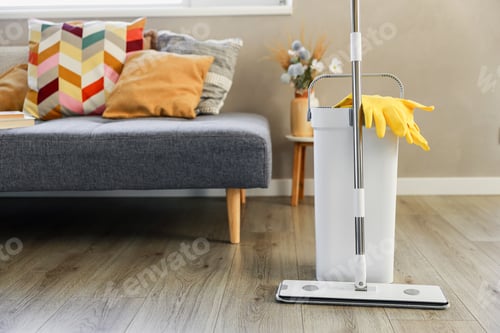 Preview: Cleaning supplies: mop, gloves, bucket with wringer on wooden laminate floor