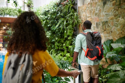 Preview: Woman with suitcase following husband
