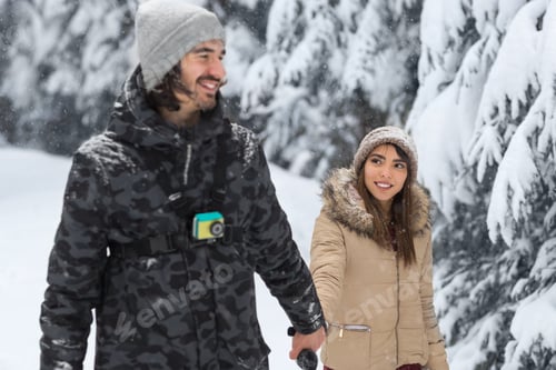 Preview: Young Romantic Couple Walking In Snow Forest Outdoor Mix Race man And Woman Holding Hands