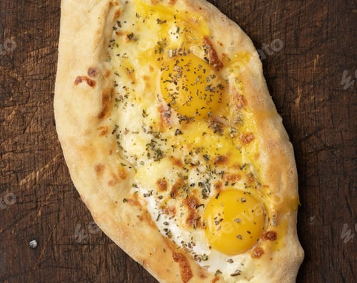 Preview: Baked adjarian khachapuri with whole egg yolk on wooden board