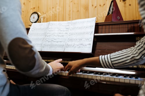 Preview: Man playing piano near woman teaching in studio