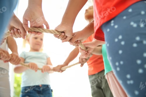 Preview: Little children holding rope on light background, focus on hands. Unity concept