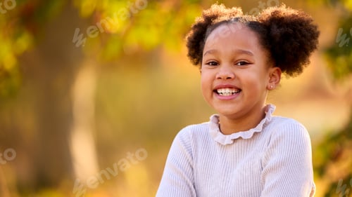 Preview: Head And Shoulders Portrait Of Smiling Young Girl Outdoors In Countryside