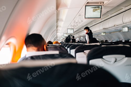 Preview: Back of people's heads as they wait for takeoff on a commercial airplane.