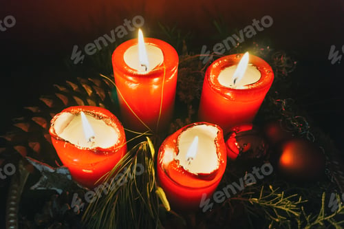 Preview: Burning candles near coniferous twigs