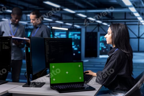 Preview: Computer scientist using green screen notebook to oversee blade servers