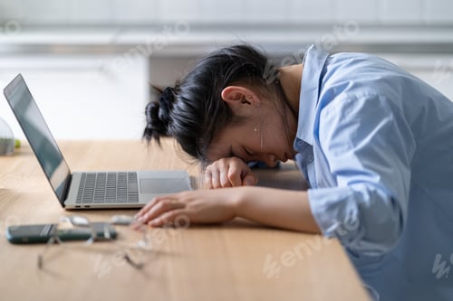 Preview: Work burnout. Tired asian woman putting head down on table, suffering from chronic job stress.
