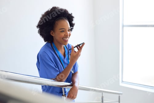Preview: Female Doctor Or Nurse Talking Into Mic Of Mobile Phone On Stairs In Hospital