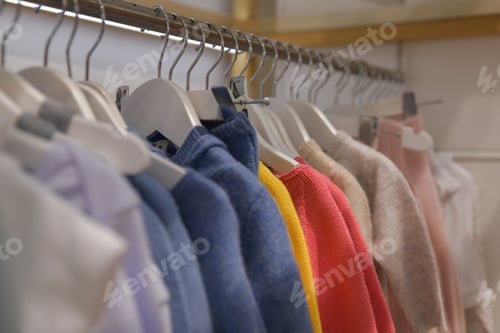 Preview: Blouses and sweaters hang on a hanger in the store