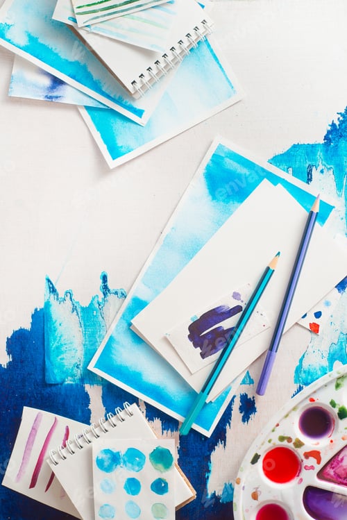 Preview: Artistic Composition of Watercolor Supplies and Paintings