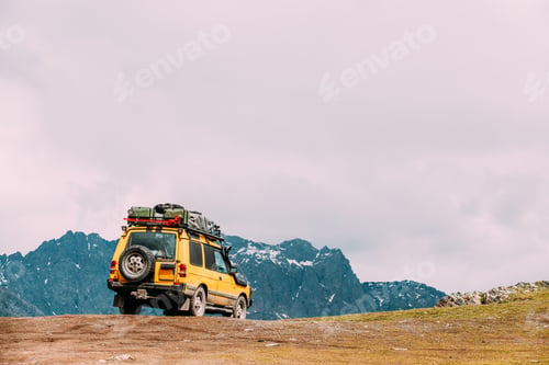 Preview: Yellow SUV Car On Off Road In Spring Mountains Landscape. Drive