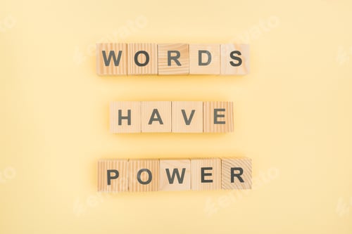 Preview: top view of phrase words have power lettering with wooden cubes on yellow background