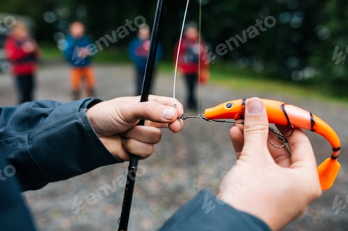 Preview: Close-up of person holding fishing lure