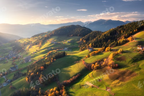 Preview: Aerial view of amazing green alpine meadows, orange trees, hills