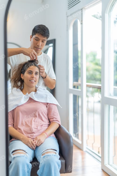 Preview: Hairdresser attending a client in a hair salon