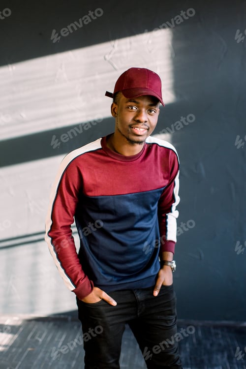 Preview: African male fashion model dressed in in red baseball cap
