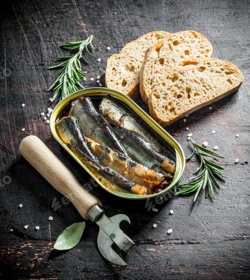 Preview: Sprats in a tin with sliced bread and rosemary.
