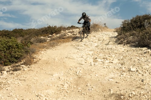 Preview: Professional bike rider during downhill ride on his bicycle