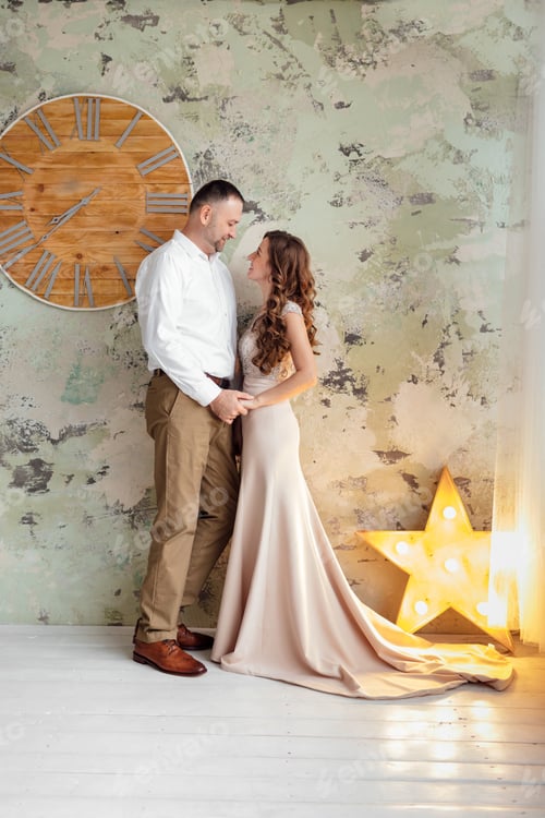 Preview: Photo shoot in the studio of a young married couple. A guy with a girl in festive clothes