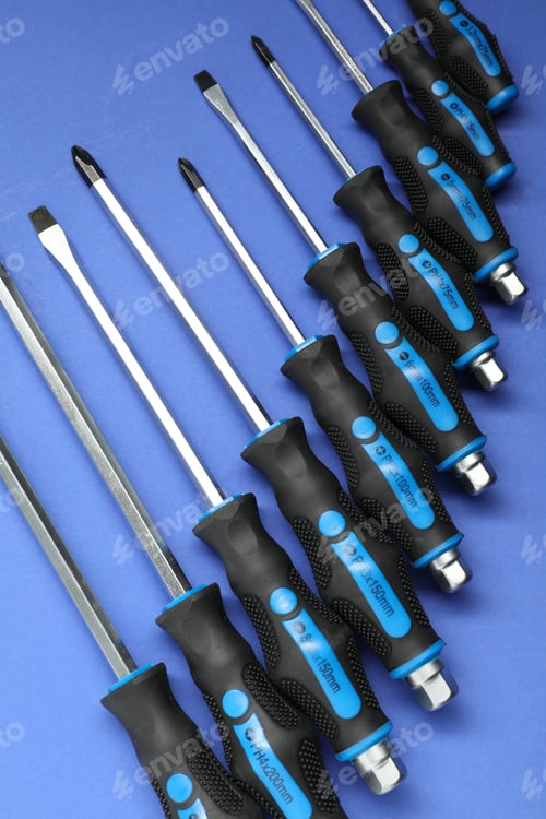 Preview: Set of screwdrivers on blue background, flat lay