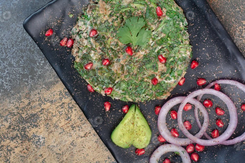 Preview: Scrambled eggs with greens on black plate