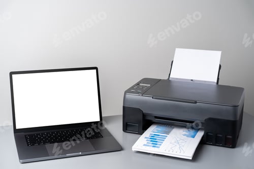 Preview: Printer and laptop on grey table in office