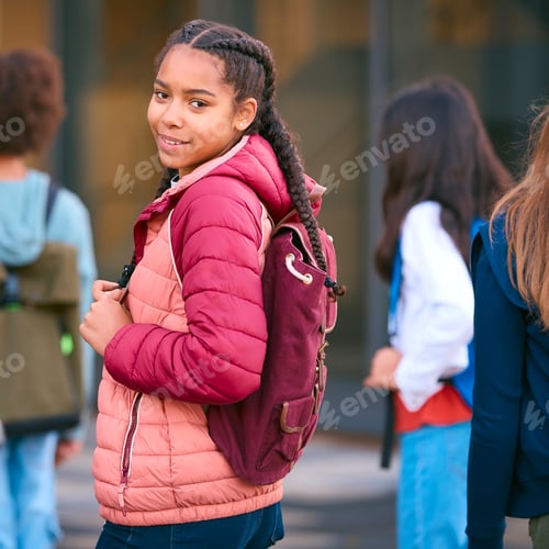 Preview: Portrait Of Female Secondary Or High School Student Outside School Building With Teachers And Pupils