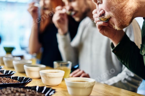 Preview: Team tasting bowls of coffee at coffee shop tasting