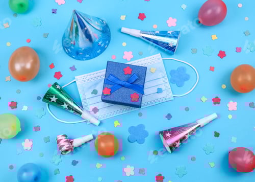 Preview: Set of medical mask, cone hat, balls, confetti, gift, pipe and confetti on a blue background.