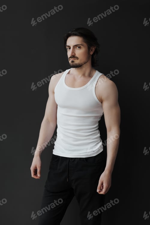 Preview: Confident man in white tank top against dark background