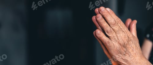 Preview: Elderly woman praying with hands. Hands folded in prayer.